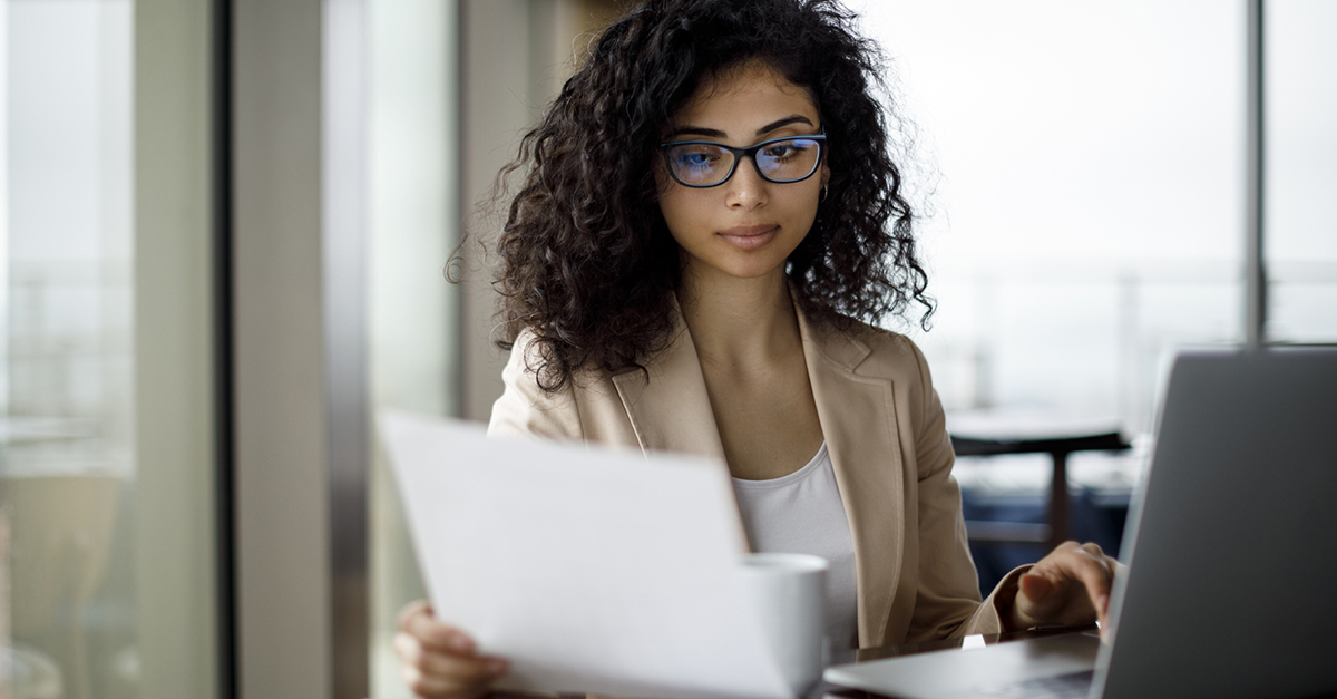 A woman looks at documents in an office